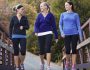 Three attractive young women talking a walking together