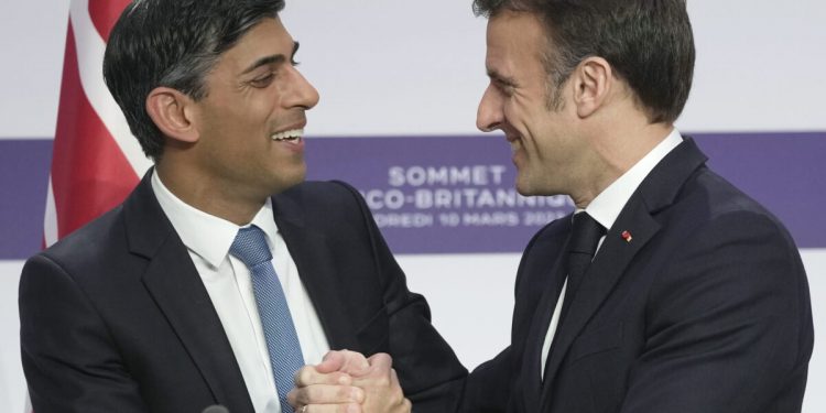 French President Emmanuel Macron, right, and Britain's Prime Minister Rishi Sunak shake hands during a joint news conference at the Elysee Palace in Paris, Friday, March 10, 2023. French President Emmanuel Macron and British Prime Minister Rishi Sunak meet Friday in Paris in a summit aimed at mending relations following post-Brexit tensions, improving military and business ties and toughening efforts against Channel migrant crossings. (AP Photo/Kin Cheung, Pool)