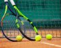 Two tennis rackets and balls leaned against the net.