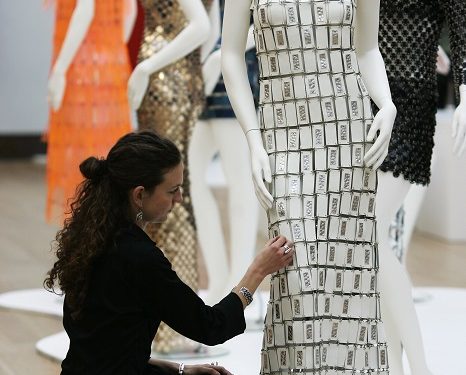 A Christie's auction house staff checks a Paco Rabanne wedding gown on display at the auction house in London, Tuesday, Oct. 28, 2008. The gown is to be auctioned in 'Ressurrection, Avant-Grade Fashion' sale on Oct. 30 with an estimated price of 6,000 to 8,000 pounds (US$9,407 to 12,543 or euro 7,528 to 10,038). (AP Photo/Sang Tan)