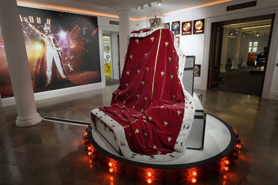 Freddie Mercury's signature crown and cloak ensemble, worn throughout the 'Magic' Tour, on display at Sotheby's auction rooms in London, Thursday, Aug. 3, 2023. More than 1,000 of Freddie Mercury's personal items, including his flamboyant stage costumes, handwritten drafts of “Bohemian Rhapsody” and the baby grand piano he used to compose Queen's greatest hits, are going on show in an exhibition at Sotheby's London ahead of their sale. (AP Photo/Kirsty Wigglesworth)