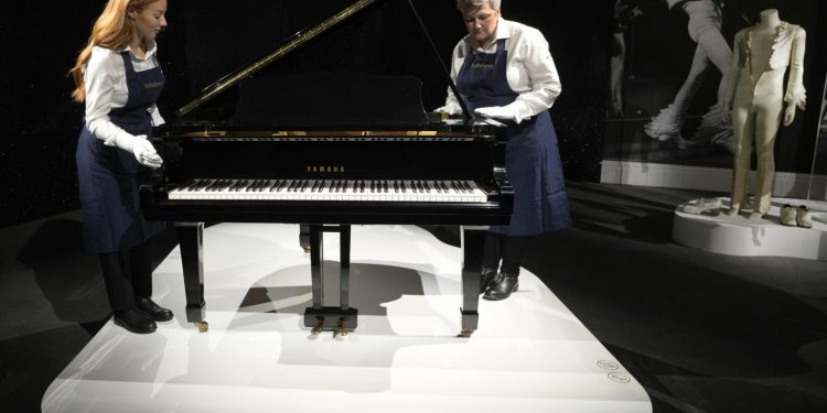 Freddie Mercury's Yamaha Grand Piano, estimated at 2-3 million pounds, on display at Sotheby's auction rooms in London, Thursday, Aug. 3, 2023. More than 1,000 of Freddie Mercury's personal items, including his flamboyant stage costumes, handwritten drafts of “Bohemian Rhapsody” and the baby grand piano he used to compose Queen's greatest hits, are going on show in an exhibition at Sotheby's London ahead of their sale. (AP Photo/Kirsty Wigglesworth)