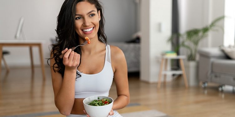 Young,Woman,Eating,A,Healthy,Salad,After,Workout.,Fitness,And