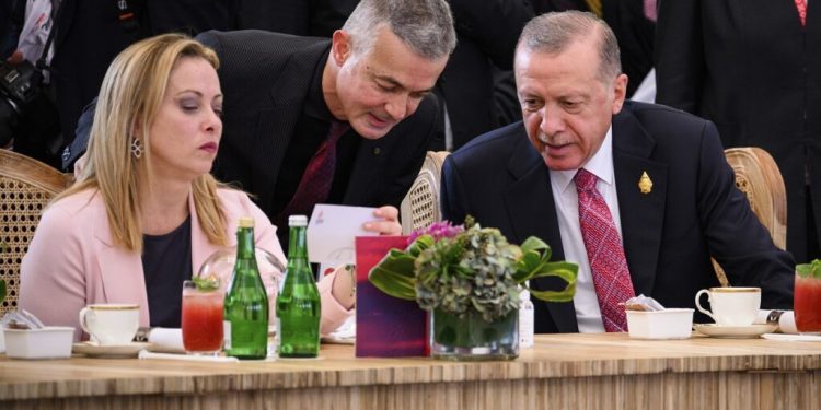 Italian Prime Minister Giorgia Meloni, left, and Turkey's President Recep Tayyip Erdogan, right, chat ahead of a working lunch at the G20 Summit in Nusa Dua, Bali, Indonesia Tuesday, Nov. 15, 2022. (Leon Neal/Pool Photo via AP)