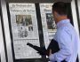 A visitor views the front page of the Washington Post, displayed outside the Newseum in Washington, Tuesday, Aug. 6, 2013, a day after it was announced that Amazon.com founder Jeff Bezos bought the Washington Post for $250 million. (AP Photo/Evan Vucci)