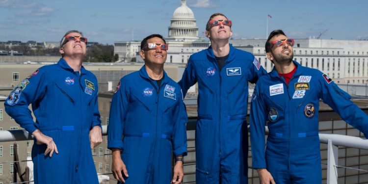 NASA astronauts Stephen Bowen, left, Frank Rubio, Warren Hoburg, and UAE (United Arab Emirates) astronaut Sultan Alneyadi, right, pose for a photo wearing solar glasses, Tuesday, March 19, 2024, at the Mary W. Jackson NASA Headquarters building in Washington. Bowen, Hoburg, and Alneyadi spent 186 days aboard the International Space Station as part of Expedition 69; while Rubio set a new record for the longest single spaceflight by a U.S. astronaut, spending 371 days in orbit on an extended mission spanning Expeditions 68 and 69. Photo Credit: (NASA/Aubrey Gemignani)