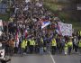 Students walk on the road towards the northern city of Novi Sad, where they will participate in a 24 hour block of three bridges to protest the deaths of 15 people killed in the November collapse of a train station canopy, near the Belgrade suburb of Batajnica, Serbia, Thursday, Jan. 30, 2025. (AP Photo/Darko Vojinovic)