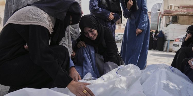 Palestinians react next to the bodies of their relatives, killed in an Israeli army strike, before their burial at a hospital in Khan Younis, Gaza Strip on Wednesday, April 2, 2025. (AP Photo/Abdel Kareem Hana)